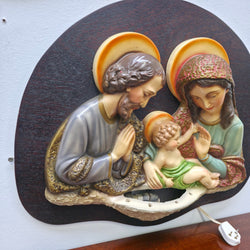 Detailed angled view of Mary, Joseph and Jesus on vintage wall plaque