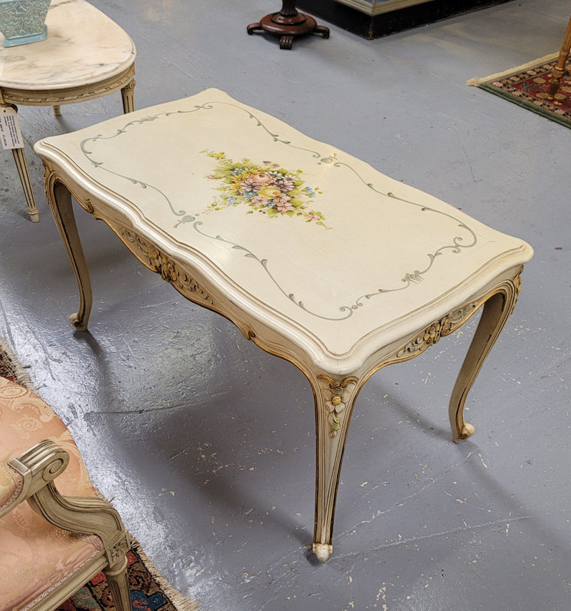 Delightful Vintage French Louis 15th style coffee table with original painted floral centerpiece and gilded highlights. It has been sourced from France and are in good original condition.