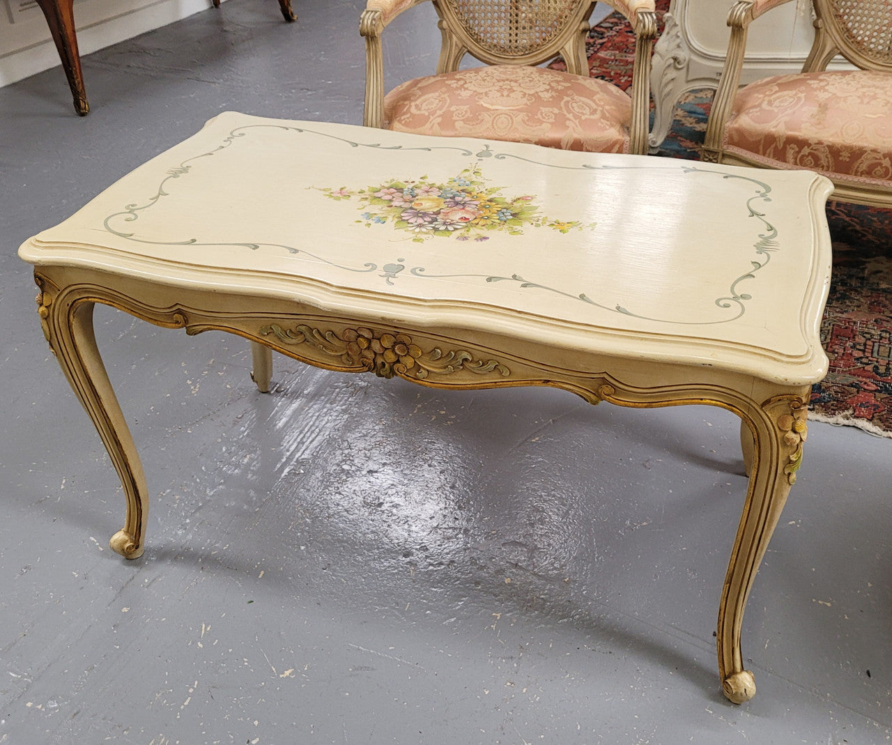 Delightful Vintage French Louis 15th style coffee table with original painted floral centerpiece and gilded highlights. It has been sourced from France and are in good original condition.