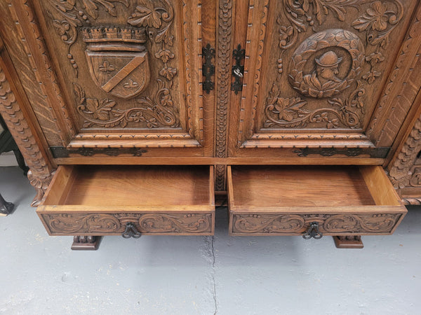 Large French Oak Renaissance style four door sideboard/buffet. Great decorative item with amazing carvings and stunning iron work on base. It is in good original detailed condition. Can pull apart completely making it easier to move.