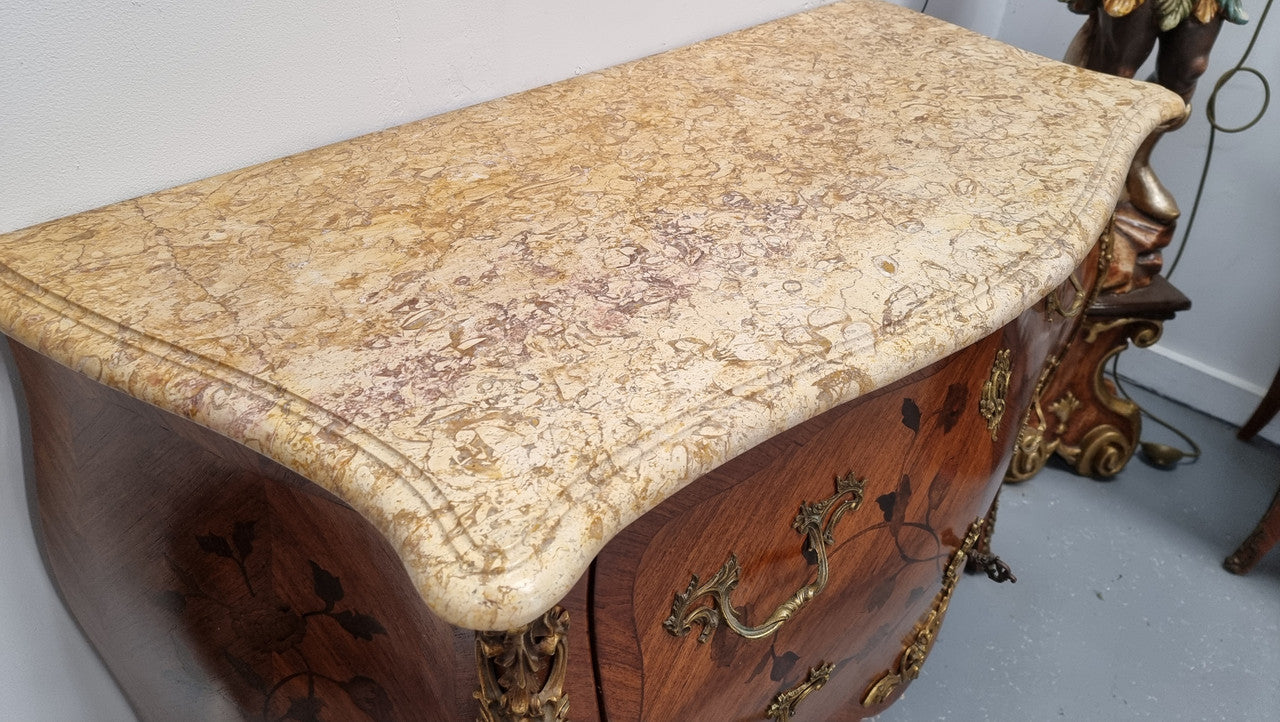 Louis XV style marquetry inlay marble top two drawer commode. It has decorative ormolu mounts and beautiful marble top. In good original detailed condition and has been sourced from France.