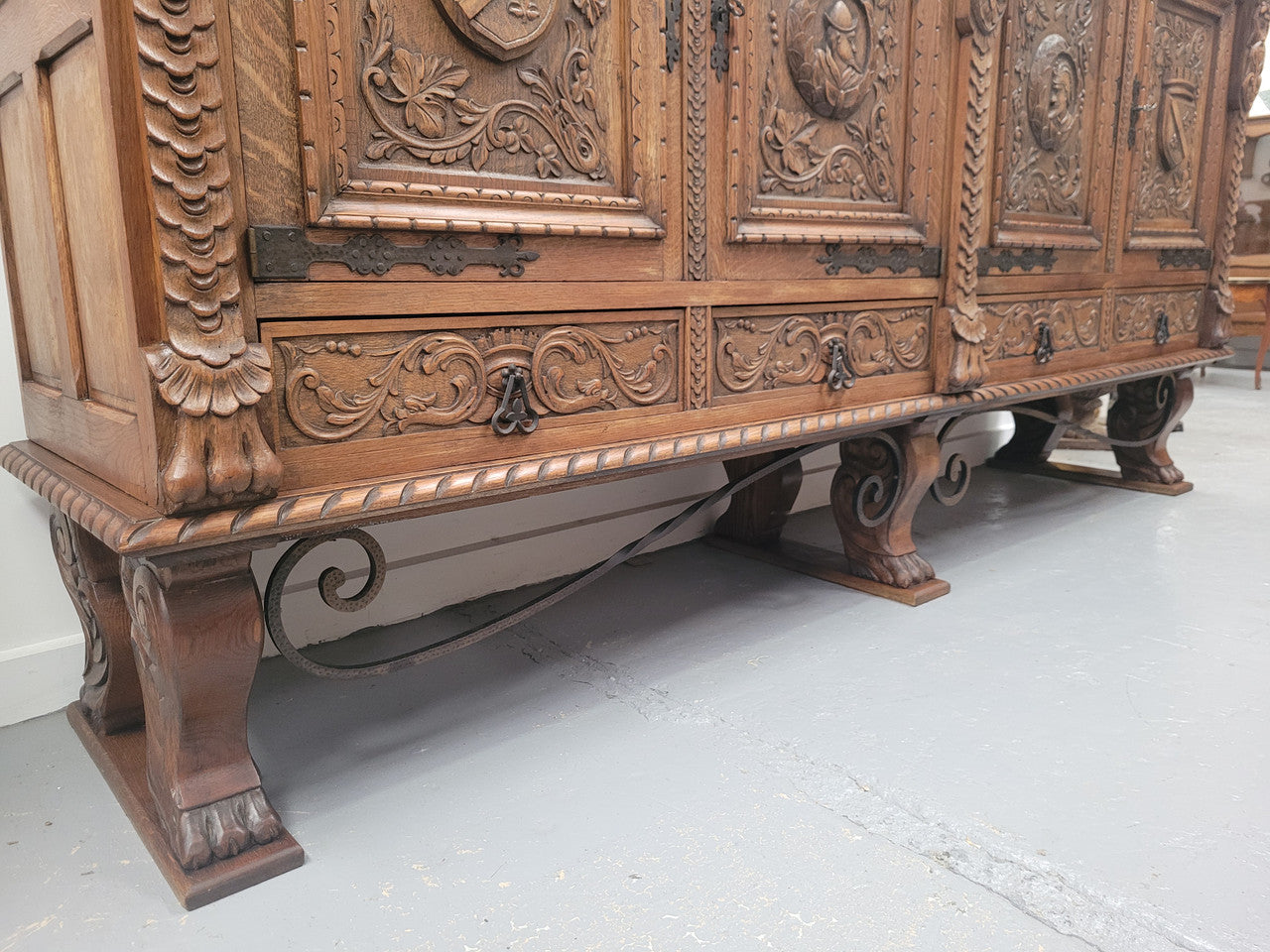 Large French Oak Renaissance style four door sideboard/buffet. Great decorative item with amazing carvings and stunning iron work on base. It is in good original detailed condition. Can pull apart completely making it easier to move.