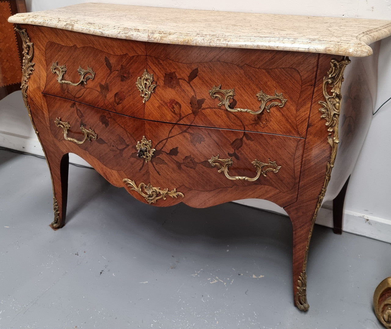 Louis XV style marquetry inlay marble top two drawer commode. It has decorative ormolu mounts and beautiful marble top. In good original detailed condition and has been sourced from France.