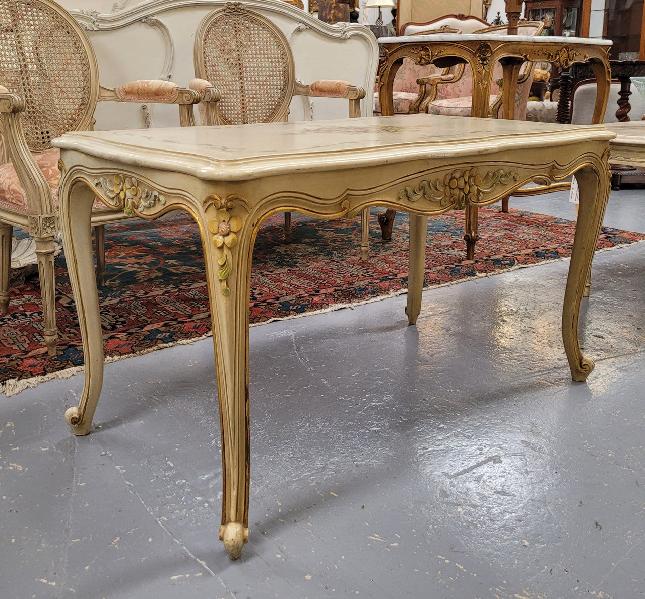 Delightful Vintage French Louis 15th style coffee table with original painted floral centerpiece and gilded highlights. It has been sourced from France and are in good original condition.