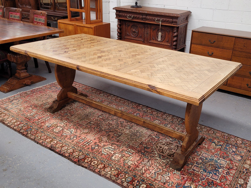 French parquetry top Fruitwood dining table with loads of character and comfortably fits eight people. It has been sourced from France and is in good original detailed condition.