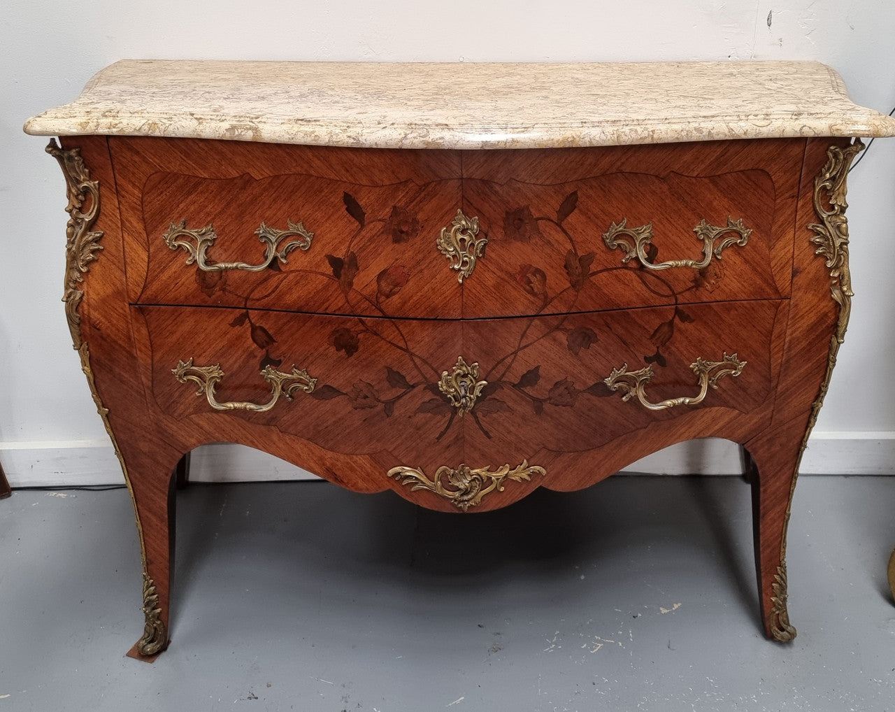 Louis XV style marquetry inlay marble top two drawer commode. It has decorative ormolu mounts and beautiful marble top. In good original detailed condition and has been sourced from France.