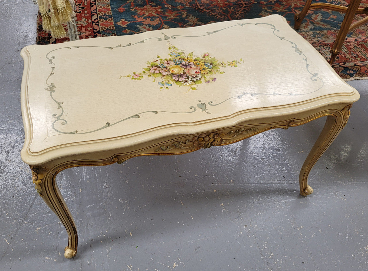 Delightful Vintage French Louis 15th style coffee table with original painted floral centerpiece and gilded highlights. It has been sourced from France and are in good original condition.