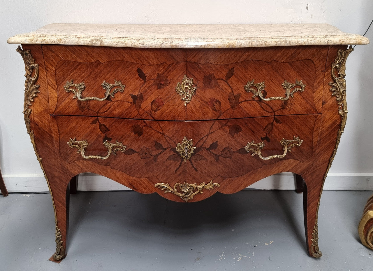 Louis XV style marquetry inlay marble top two drawer commode. It has decorative ormolu mounts and beautiful marble top. In good original detailed condition and has been sourced from France.