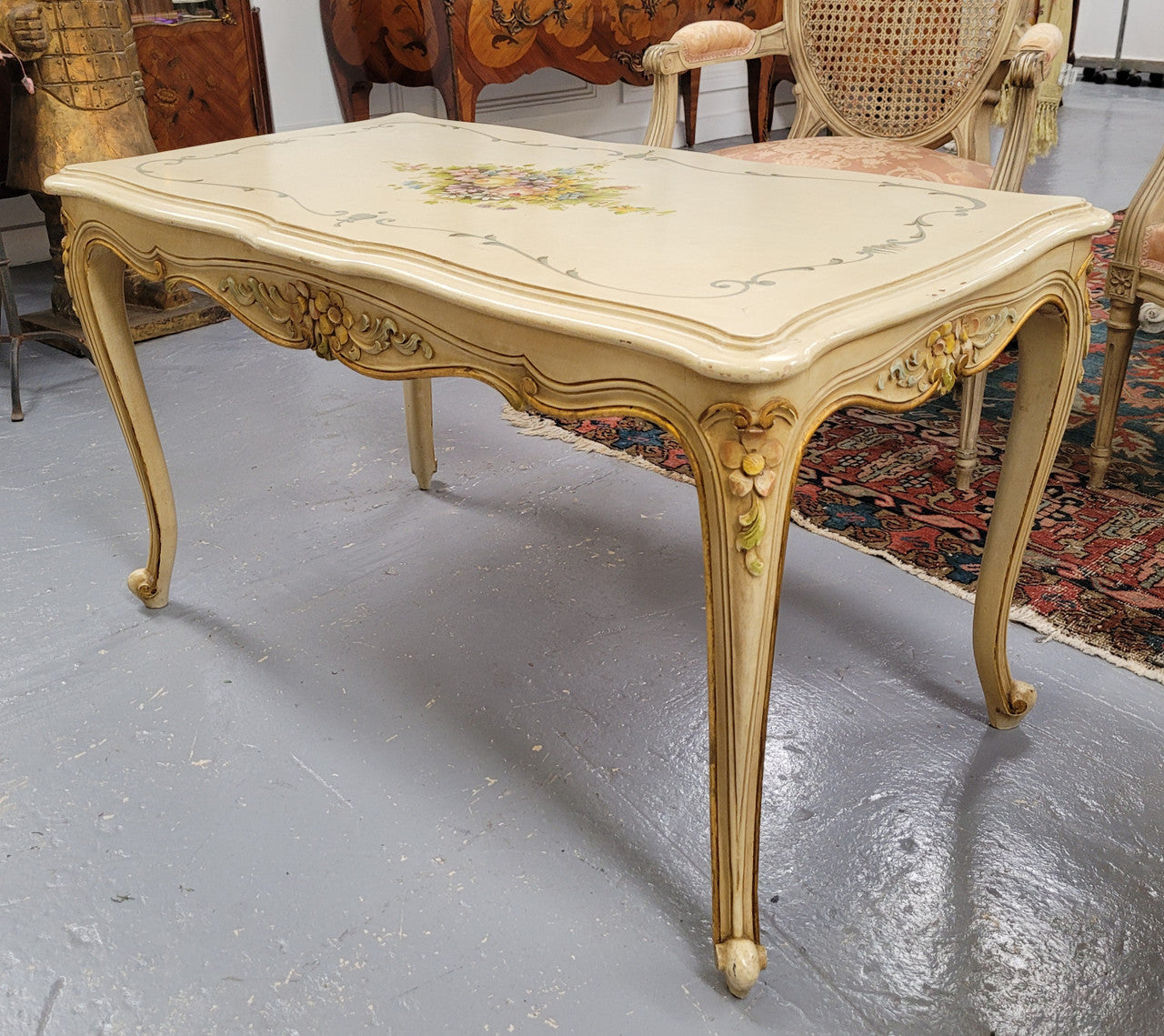 Delightful Vintage French Louis 15th style coffee table with original painted floral centerpiece and gilded highlights. It has been sourced from France and are in good original condition.