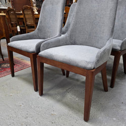 Detail of grey upholstery and tapered timber legs