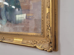 Close detail of the ornate gilt frame and decorative corner