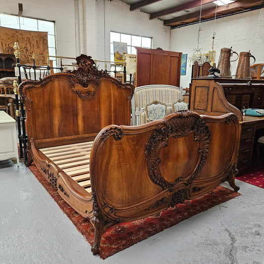 Beautifully carved Antique Louis XV style French Walnut queen size bed. Comes with custom made bed slates. Sourced from France and in good original detailed condition.