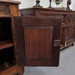 Vintage wooden cabinet with intricate carvings on a white floor.