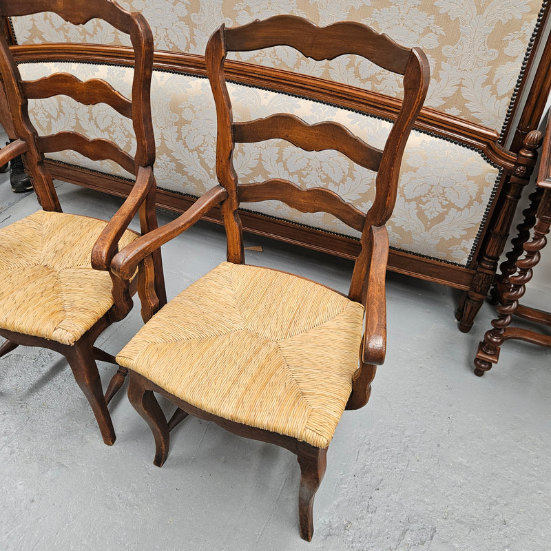 Set of ten French oak rush seats with eight dining chairs and two carvers. They have a comfortable wide rush seat and are in good original condition.