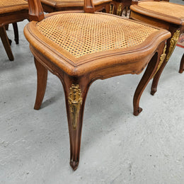 Stunning set of eight French Louis XV style walnut cane seat with upholstered back and ormolu mounts on the legs. Circa 1900. They are in excellent original condition and very comfortable. Please see photos as they form part of the description and condition.