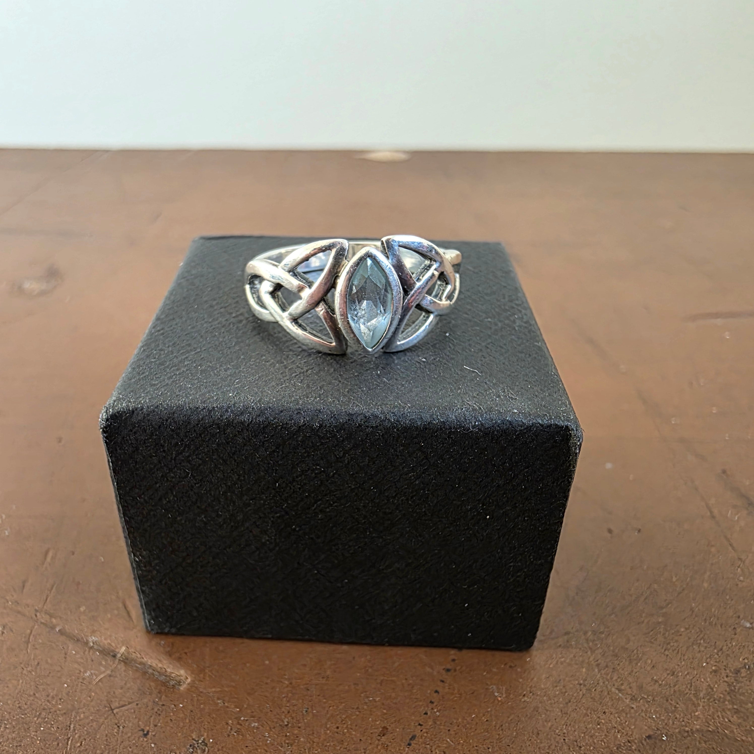 Front view of sterling silver Celtic knot ring with marquise-shaped blue stone