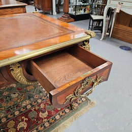 An exceptional French 19th Century Louis XV style "Bureau Plat" tooled leather top desk. Made from kingwood and rosewood, It has superb gilt cast ormolu mounts all the way around which means it can be used floating in the center of a room. In very good restored condition.