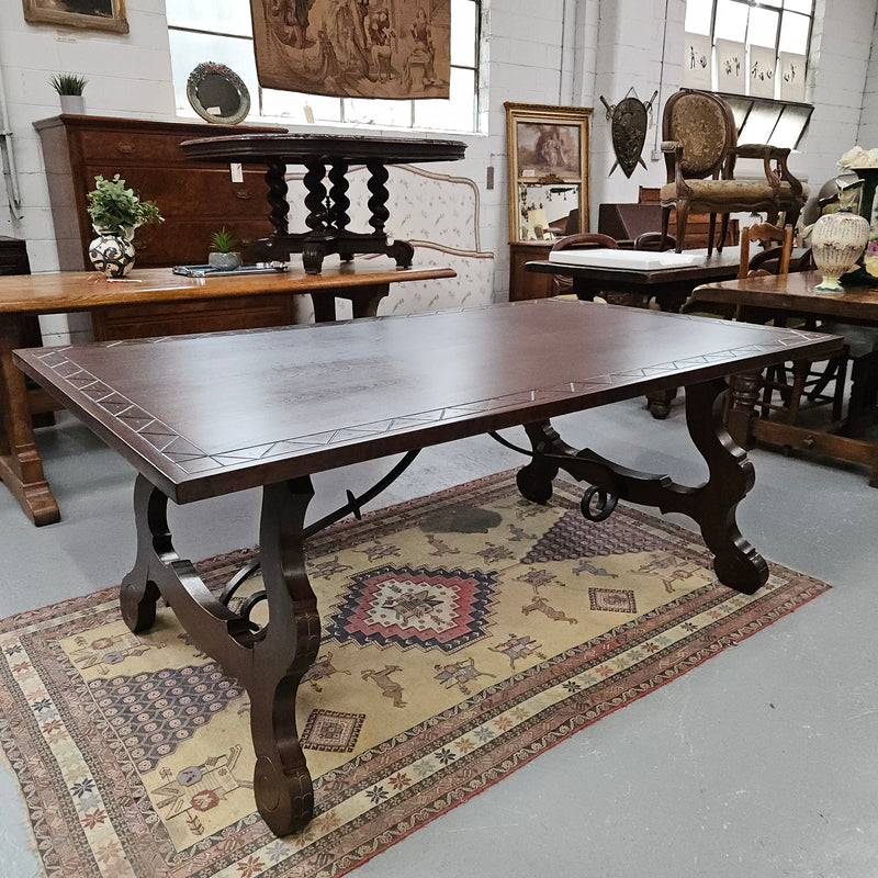 Vintage walnut Spanish style farmhouse table with a beautiful top and iron work. It is in good restored condition. Circa 1950'S.