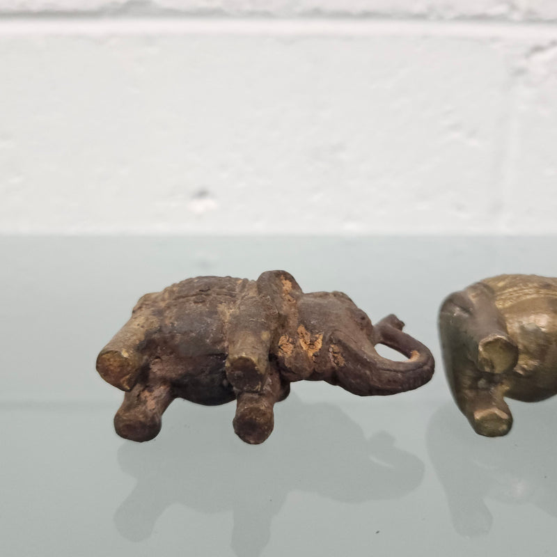 Pair of vintage aged brass elephants with raised trunks, in good original condition.