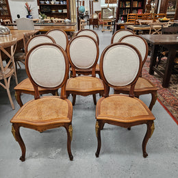 Stunning set of eight French Louis XV style walnut cane seat with upholstered back and ormolu mounts on the legs. Circa 1900. They are in excellent original condition and very comfortable. Please see photos as they form part of the description and condition.