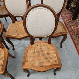 Stunning set of eight French Louis XV style walnut cane seat with upholstered back and ormolu mounts on the legs. Circa 1900. They are in excellent original condition and very comfortable. Please see photos as they form part of the description and condition.