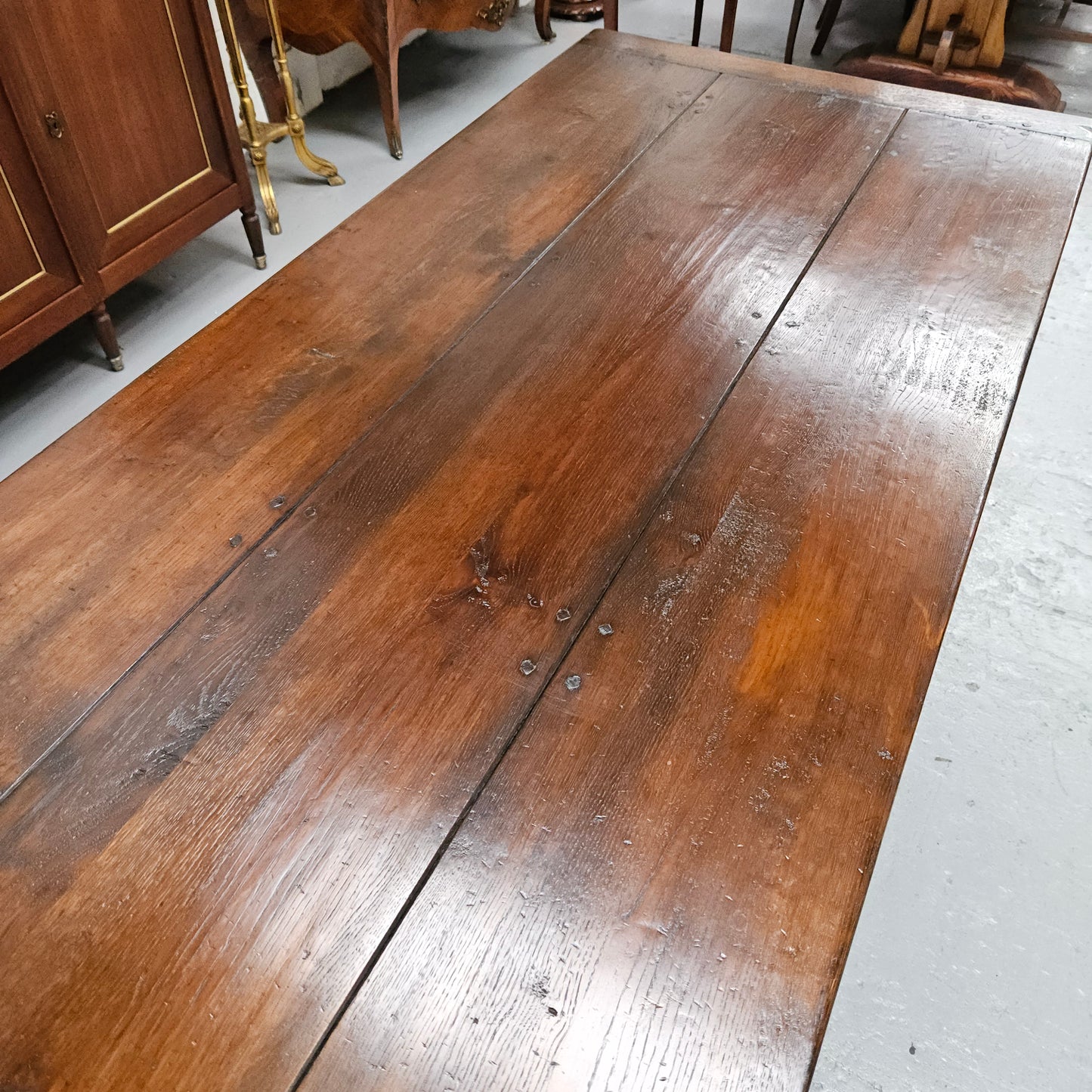 Stunning stretcher base reclaimed antique timbers farmhouse dining table with two extension leaves that can be added to either side. Sourced directly from France and is in good original detailed condition.