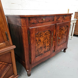 Stunning early 19th Century Elm buffet featuring two highly figured elm doors and drawers, it provides ample storage and is in good original condition.