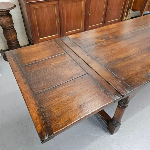 Stunning stretcher base reclaimed antique timbers farmhouse dining table with two extension leaves that can be added to either side. Sourced directly from France and is in good original detailed condition.