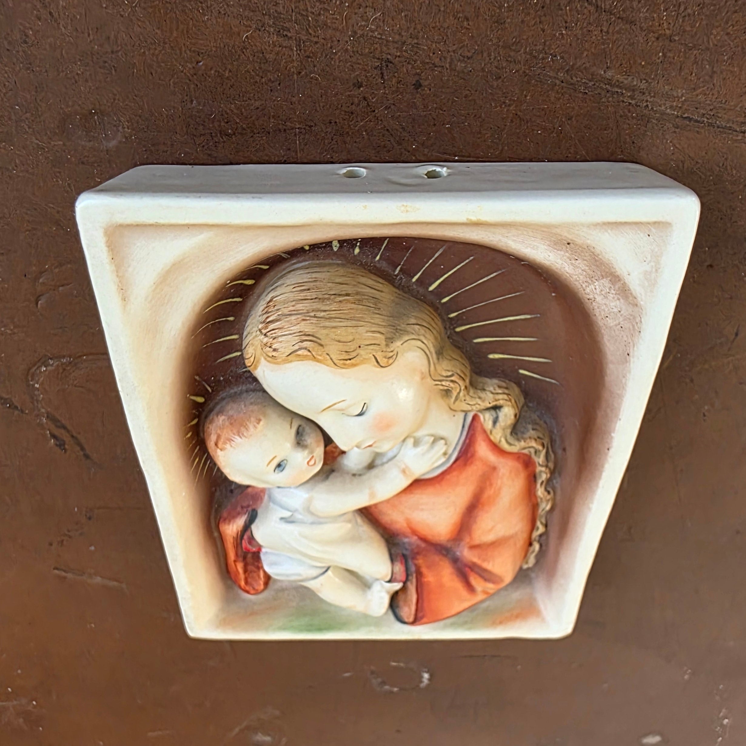 Angled view showing the raised relief and shaped frame of the Hummel ceramic wall plaque