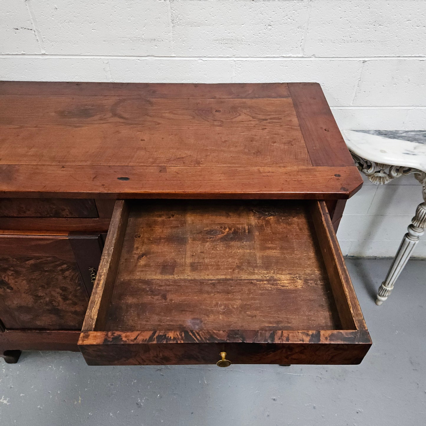 Stunning early 19th Century Elm buffet featuring two highly figured elm doors and drawers, it provides ample storage and is in good original condition.