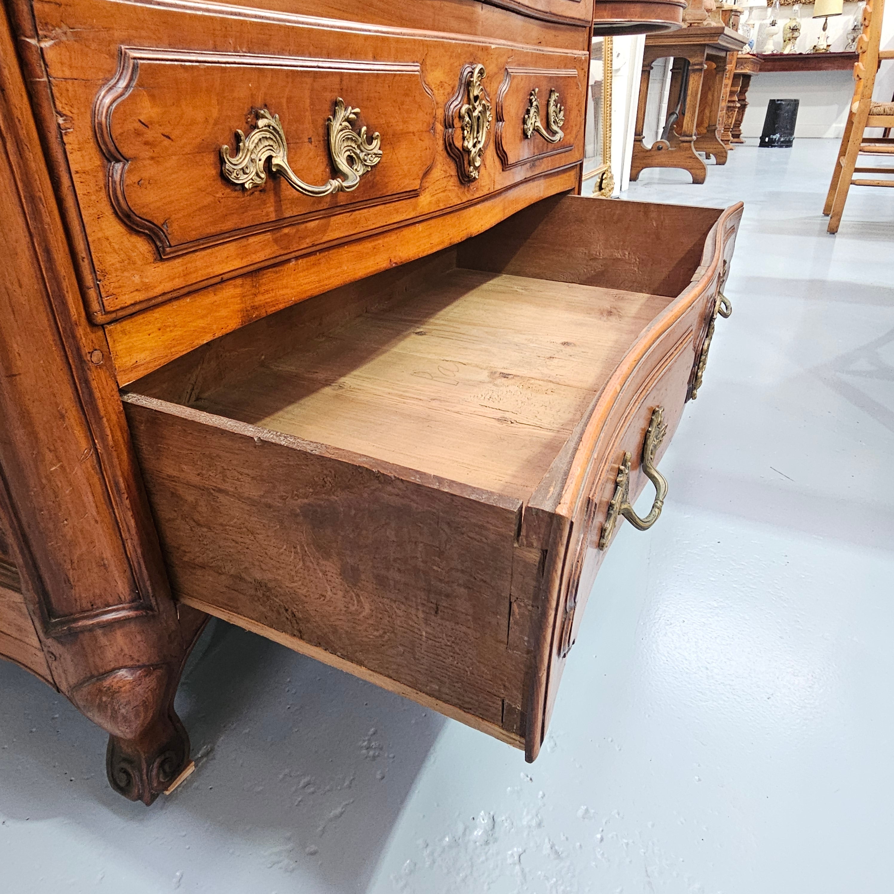 Fruitwood commode — side view of open lower drawer