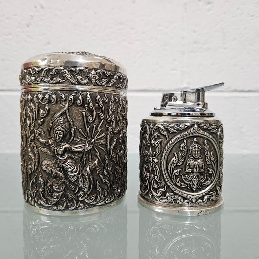 Vintage Siam sterling silver cigarette or small cigar holder and silver cased Ronson lighter. The holder in timber lined and both feature superb repousse worked decoration. The lighter hasn't been tested but it is in good original condition. Please view photos the as they help form part of the description and the condition.   Please note the measurements are for the cigarette holder.  Cigarette Holder: 170gm Lighter: 238gm
