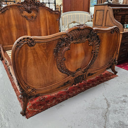 Beautifully carved Antique Louis XV style French Walnut queen size bed. Comes with custom made bed slates. Sourced from France and in good original detailed condition.