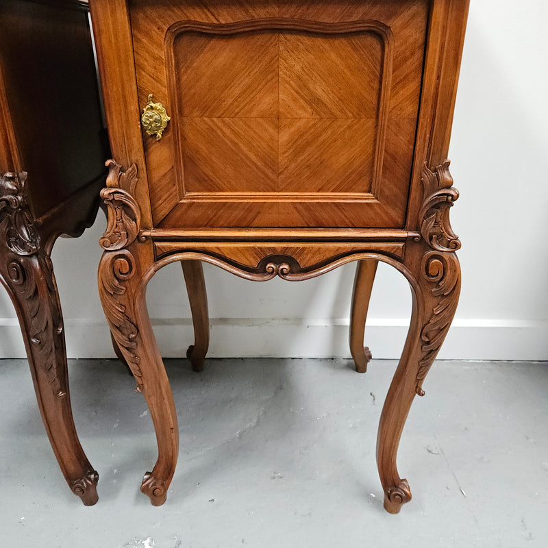 Pair of French Walnut Louis XV Style white marble top bedside cabinets. Featuring beautiful parquetry work and decorative carvings throughout. Sourced directly from France and in good original detailed condition.