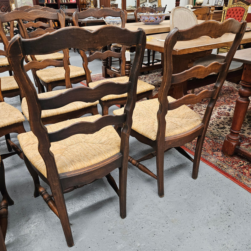 Set of ten French oak rush seats with eight dining chairs and two carvers. They have a comfortable wide rush seat and are in good original condition.