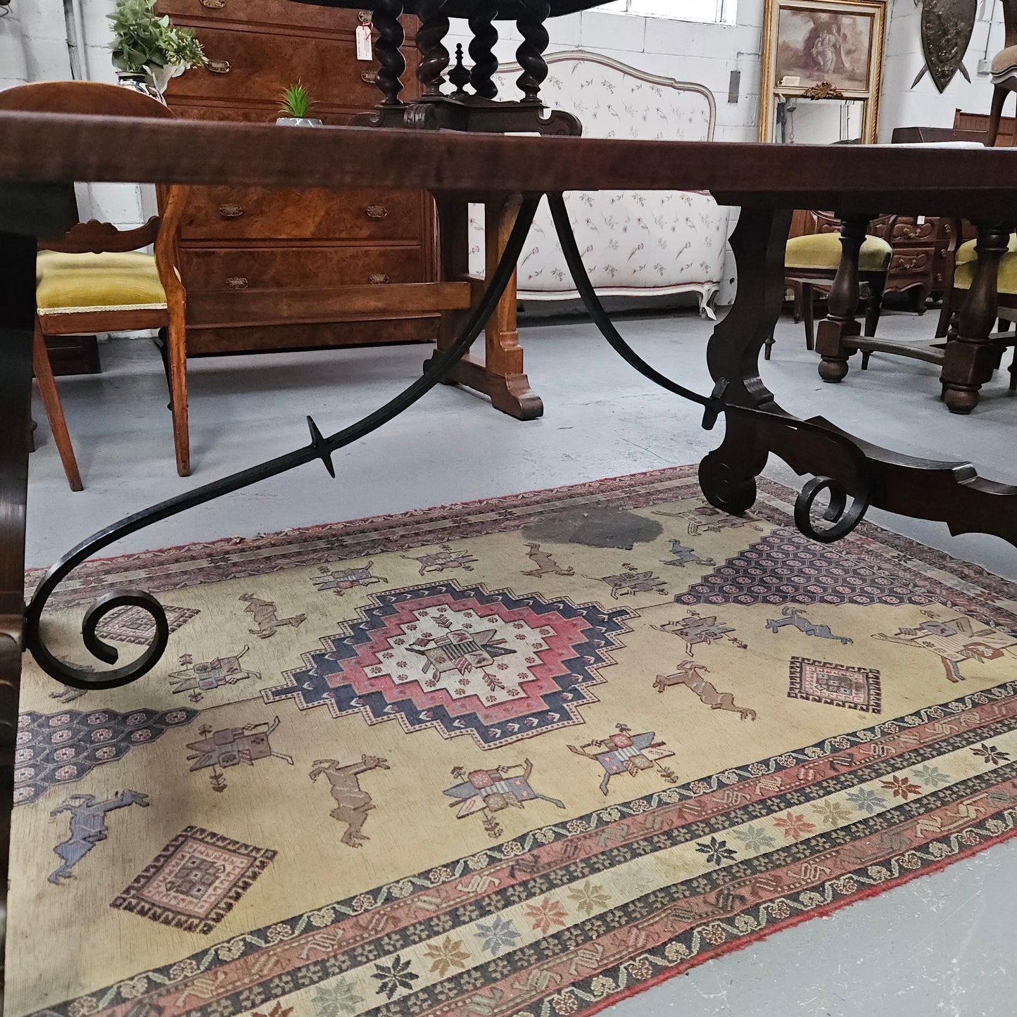 Vintage walnut Spanish style farmhouse table with a beautiful top and iron work. It is in good restored condition. Circa 1950'S.