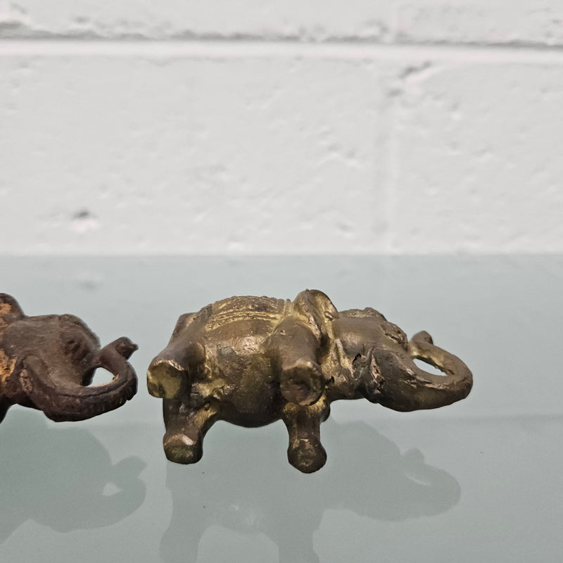 Pair of vintage aged brass elephants with raised trunks, in good original condition.