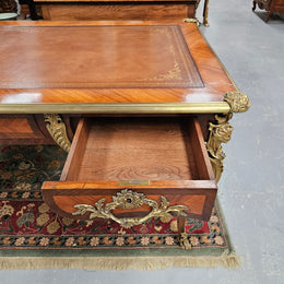 An exceptional French 19th Century Louis XV style "Bureau Plat" tooled leather top desk. Made from kingwood and rosewood, It has superb gilt cast ormolu mounts all the way around which means it can be used floating in the center of a room. In very good restored condition.