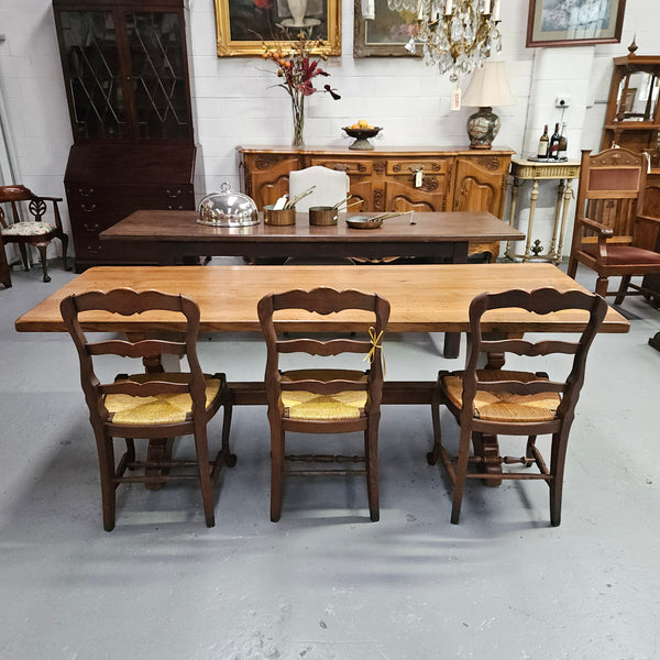 Stunning French oak monastery dining table. The top is supported on a large trestle base, and united with a single stretcher secured at each end with oak pegs. Sourced directly from France and is in good restored condition. It can seat 6-8 people comfortably.