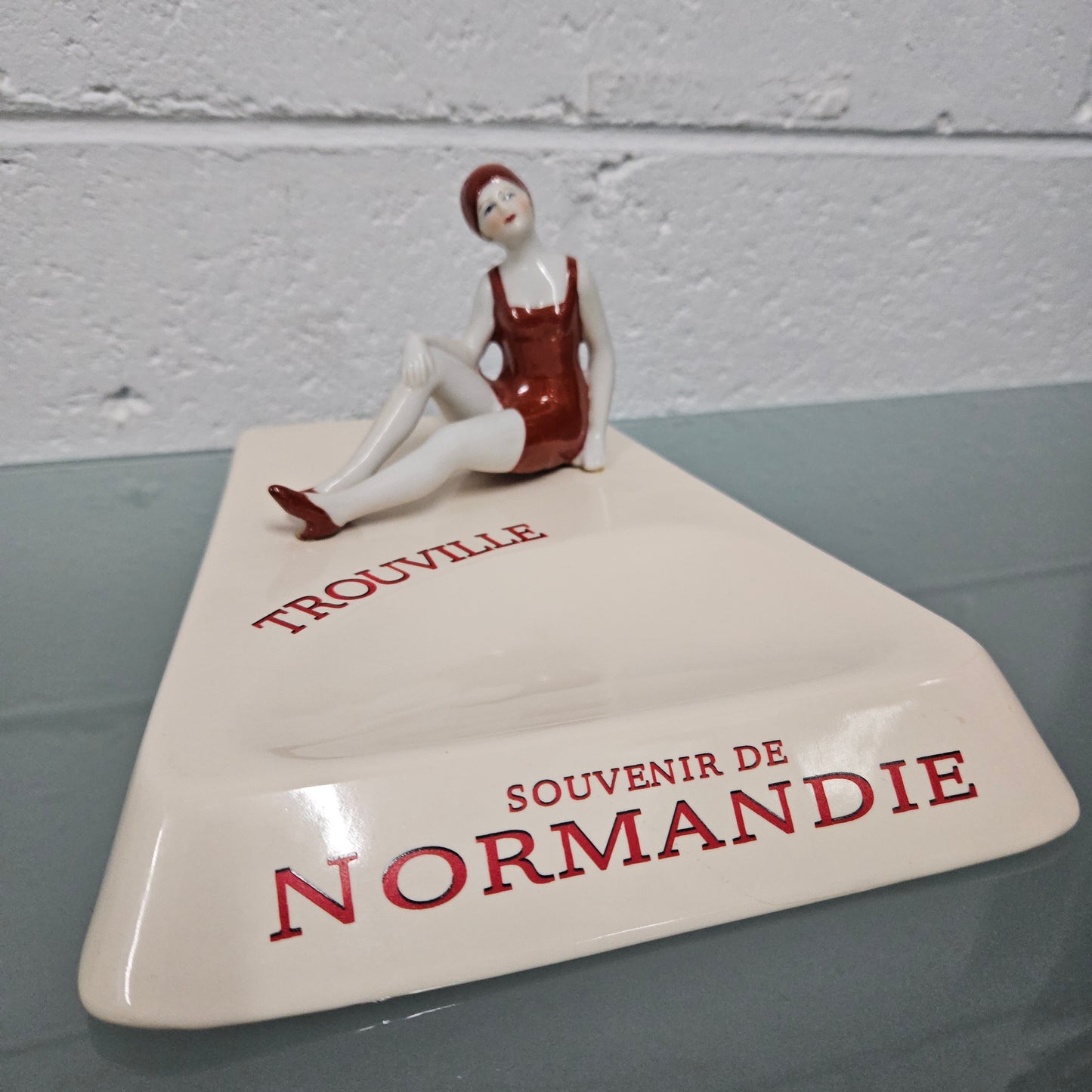 Unusual vintage female figure on large ceramic base. Souvenir Trouville De Normandie. Circa: 1950's.&nbsp; Could be used for keys, change or decoration. In good original condition.