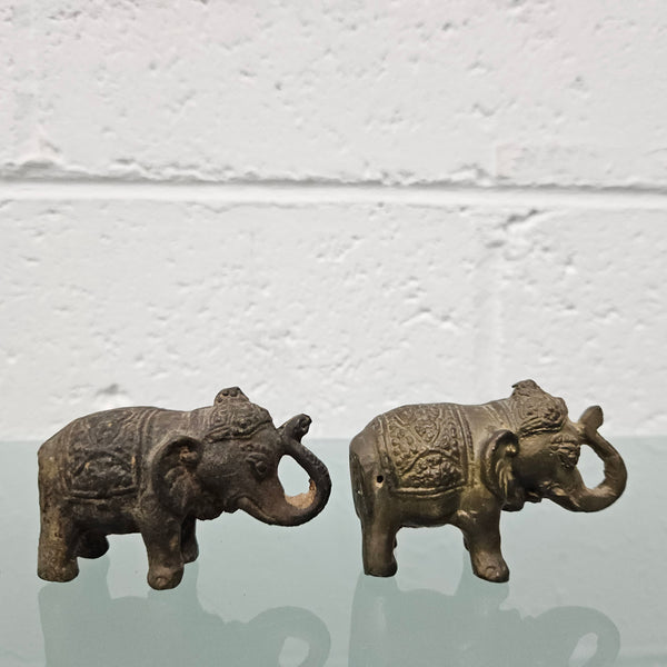 Pair of vintage aged brass elephants with raised trunks, in good original condition.