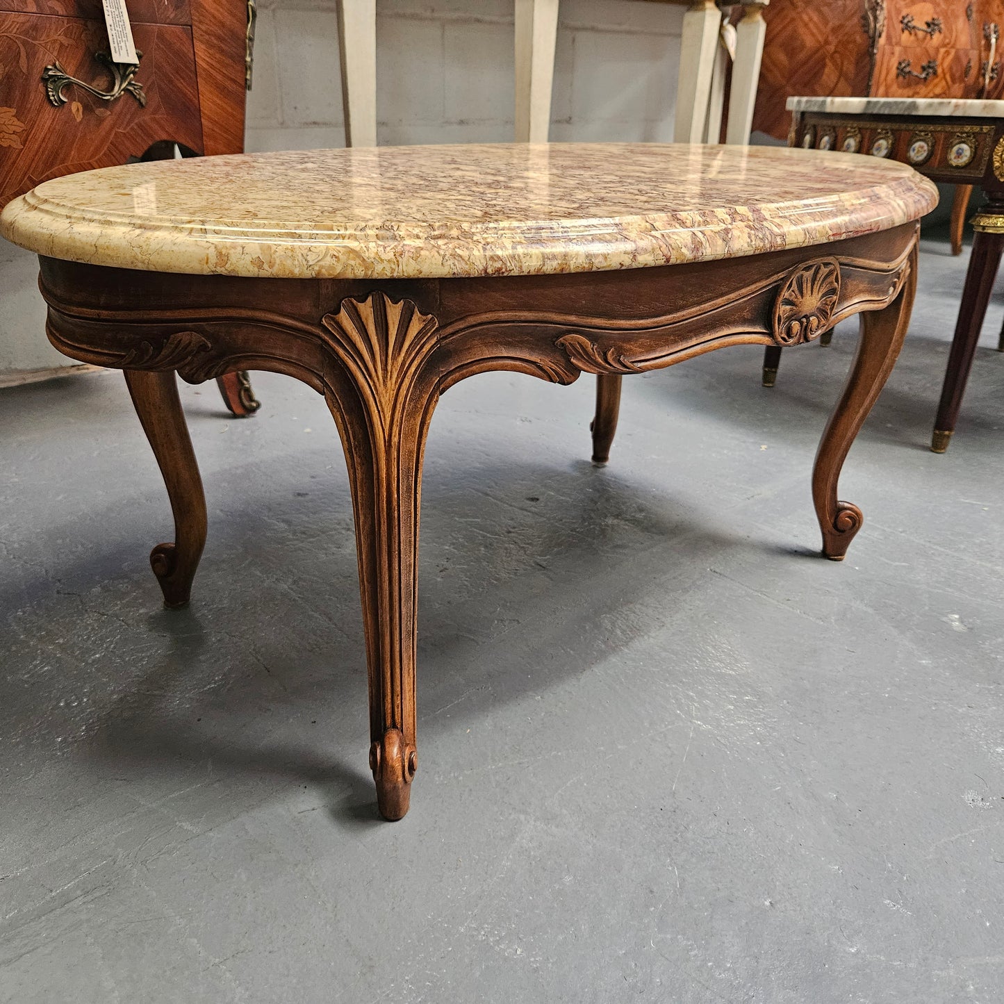 Lovely Louis XV style French fruitwood oval coffee table with a beautiful marble top. This piece is in great original condition and have been detailed to maintain its original condition.