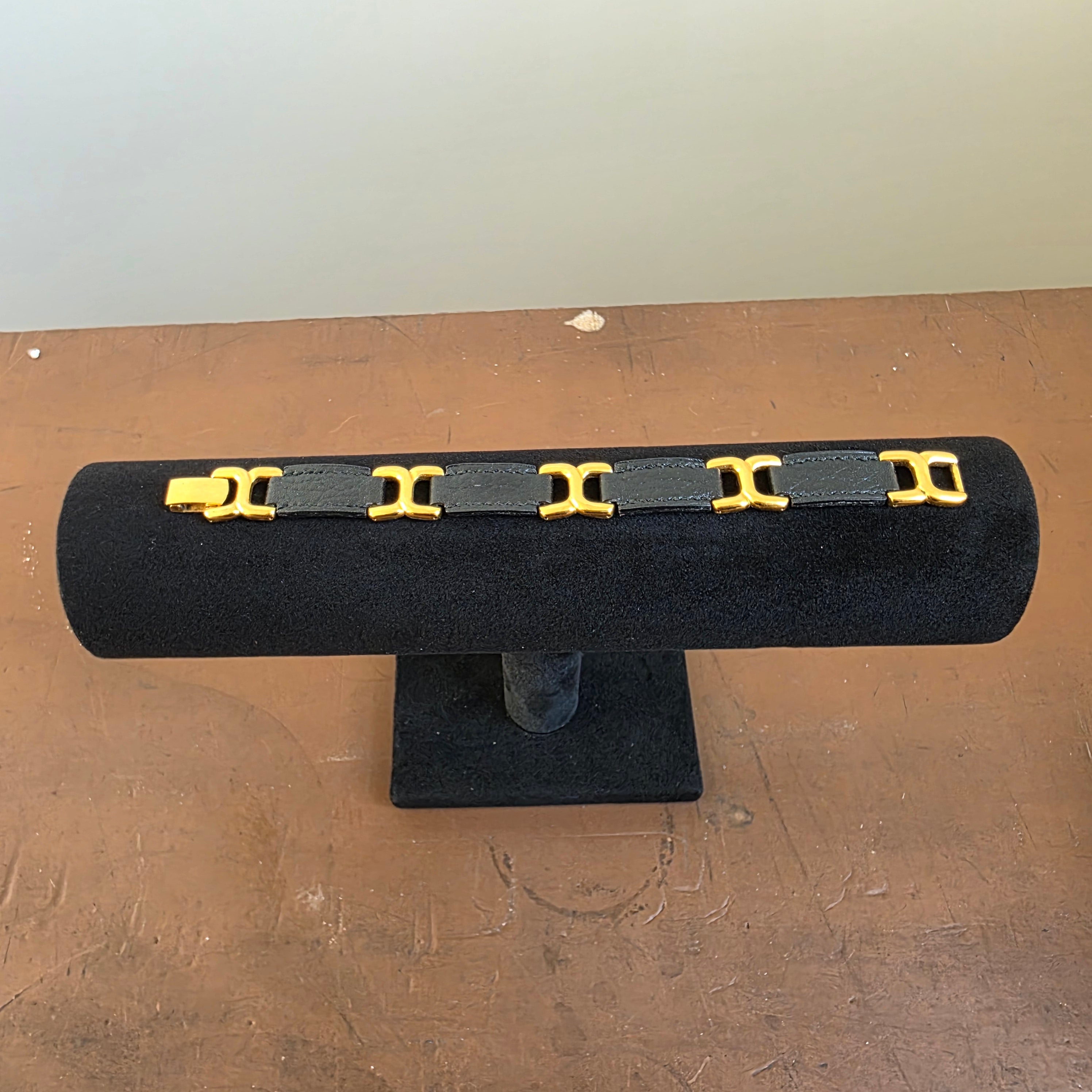 Closer front view showing five gold-plated H links joined by black leather