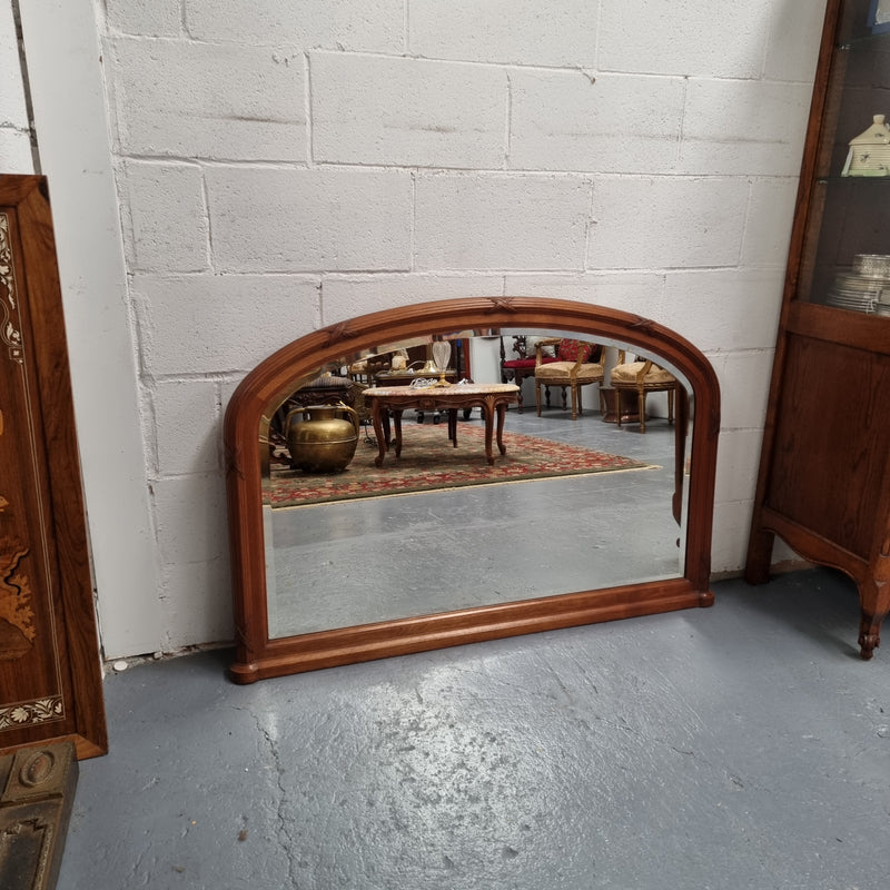 French walnut Art Deco style mantle mirror. Beautiful decorative carvings and still has its original bevelled edge mirror. Sourced directly from France and in good original condition with mirror showing some age. 