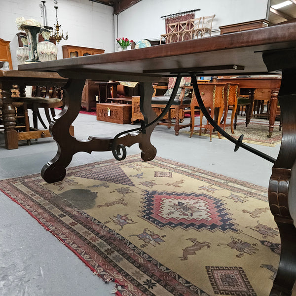 Vintage walnut Spanish style farmhouse table with a beautiful top and iron work. It is in good restored condition. Circa 1950'S.