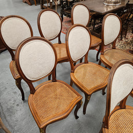Stunning set of eight French Louis XV style walnut cane seat with upholstered back and ormolu mounts on the legs. Circa 1900. They are in excellent original condition and very comfortable. Please see photos as they form part of the description and condition.