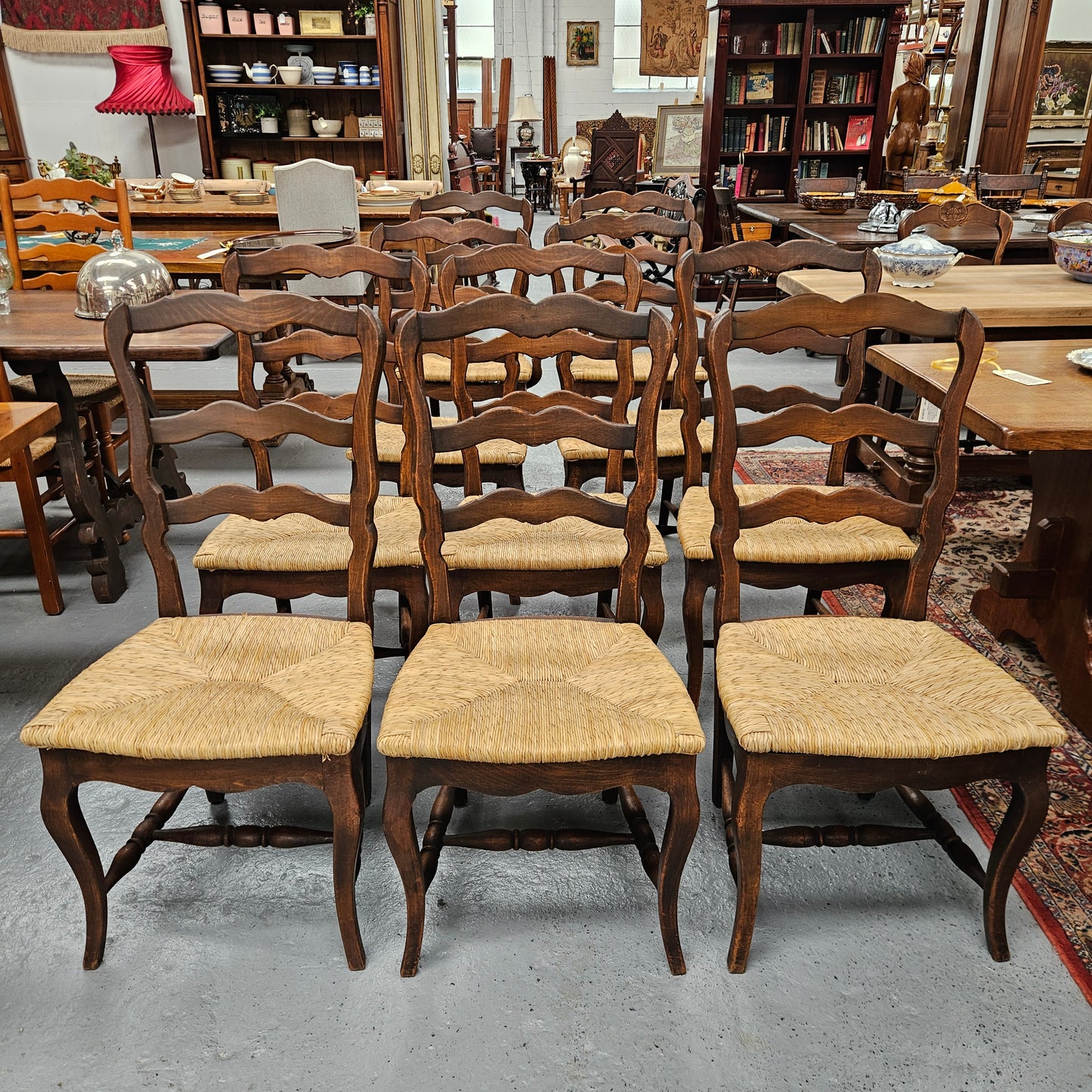 Set of ten French oak rush seats with eight dining chairs and two carvers. They have a comfortable wide rush seat and are in good original condition.