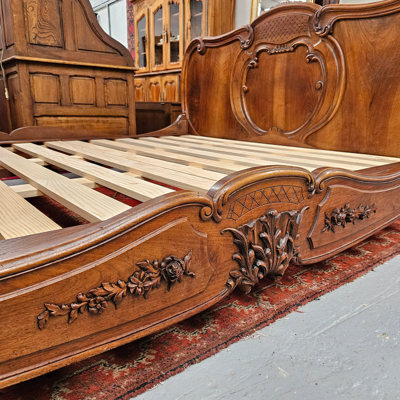 Beautifully carved Antique Louis XV style French Walnut queen size bed. Comes with custom made bed slates. Sourced from France and in good original detailed condition.