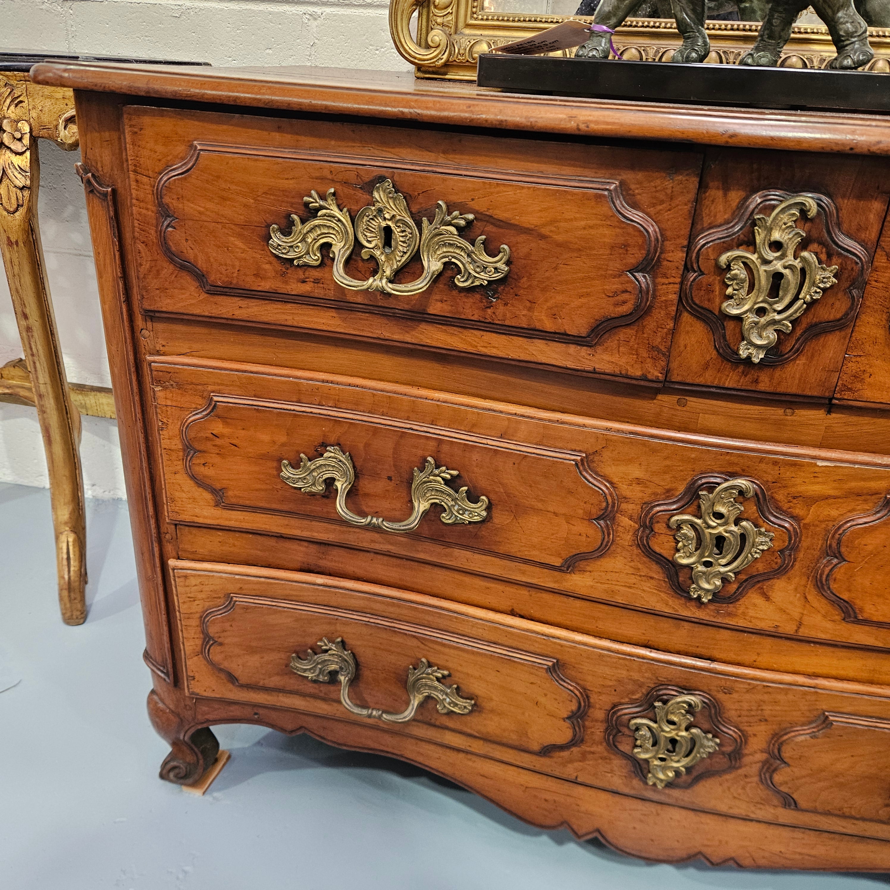 Fruitwood commode — left drawer fronts and decorative handles