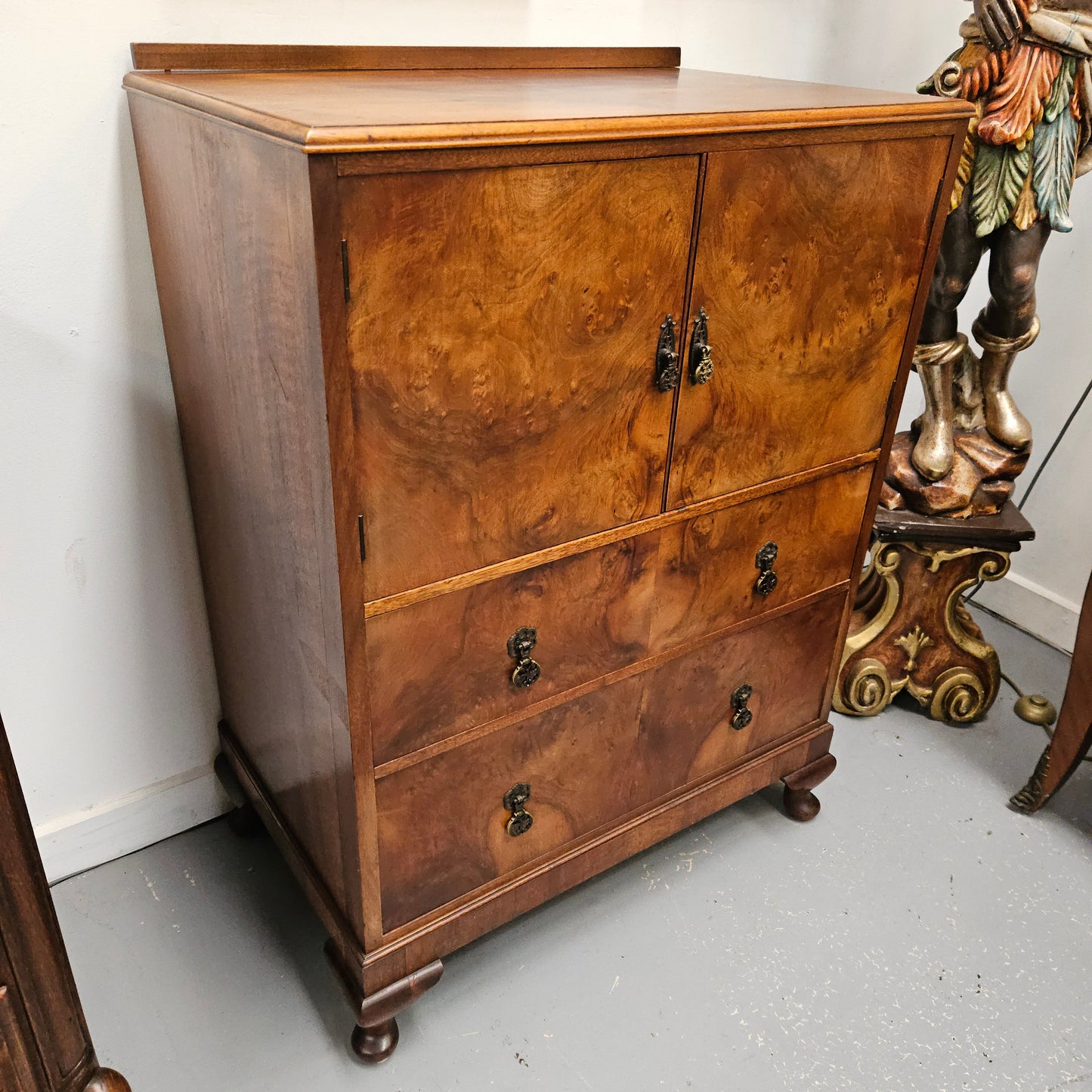 Lovely figured walnut Antique cabinet with a two door cabinet and two drawers. Circa 1930s. This cabinet can be used as a regular cabinet, drinks cabinet or tv unit as it has the hole for cables at the back. It is in good original detailed condition. 